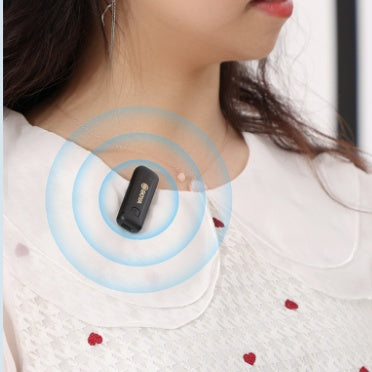 Clip-on BOYA radio microphone with black transmitter, attached to shirt neckline