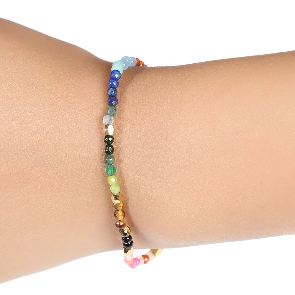 Seven chakras colored stones bracelet with multicolor bead strand and black end beads